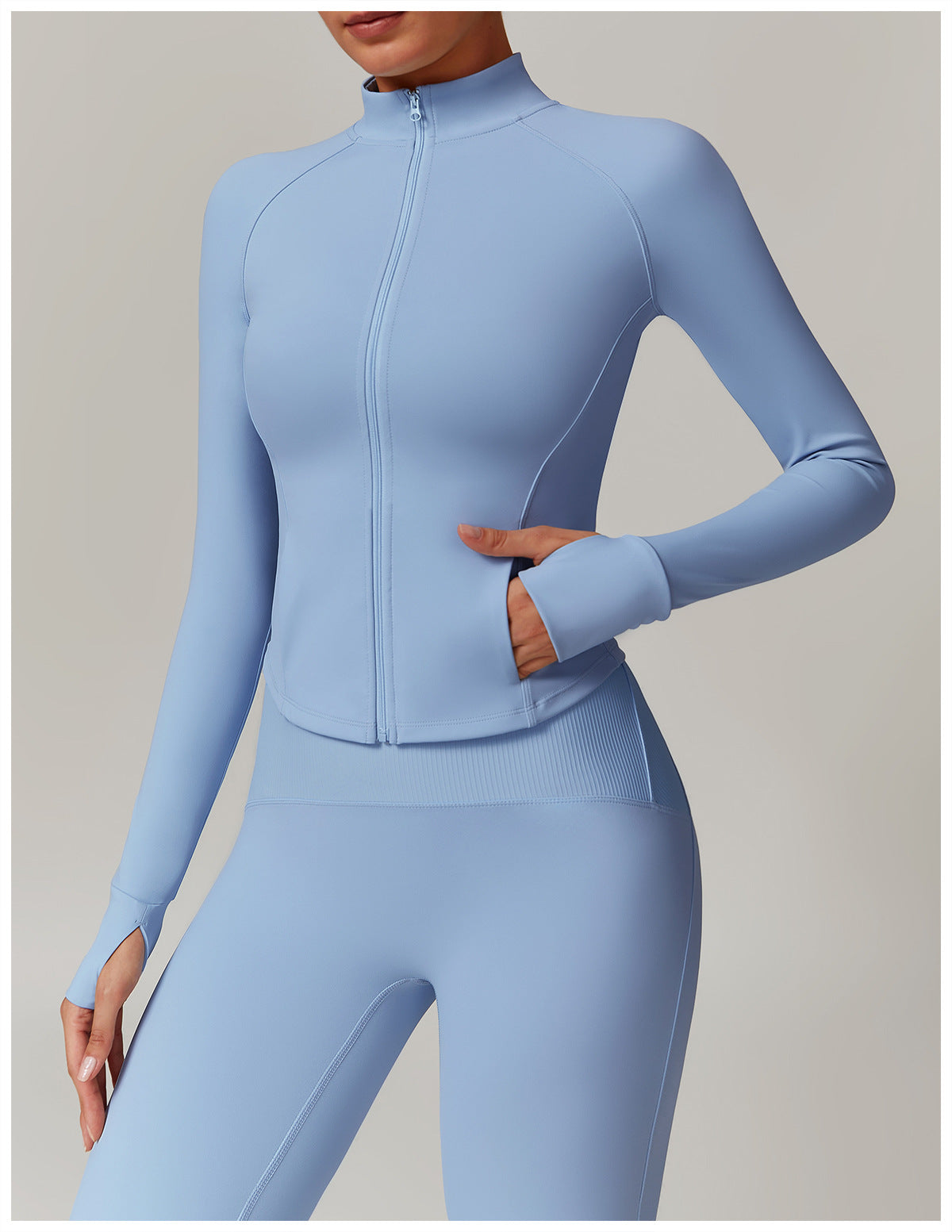 : Close-up of a woman in a light blue workout set, showing a detail shot of the sports bra, leggings, and logo.