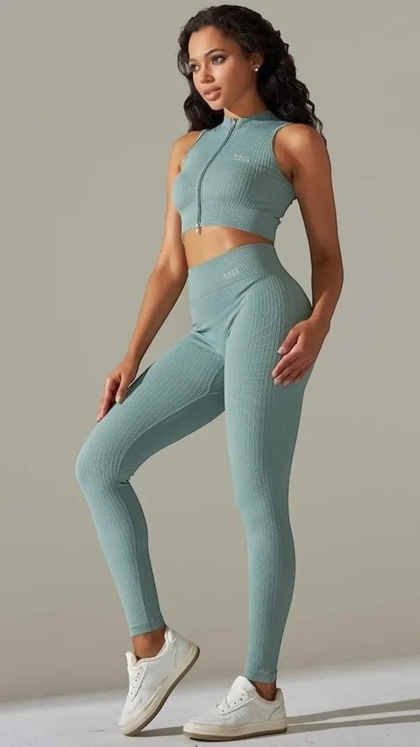 Woman wearing a light blue athletic outfit on a neutral background